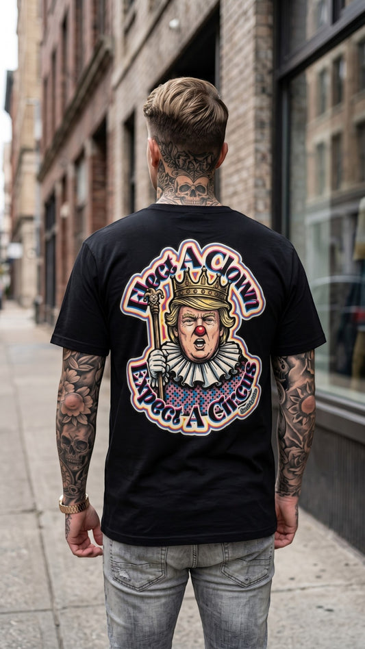 Sweet Agitator black unisex performance tee with Election Clown graphic on back, worn by a tattooed man in the city.